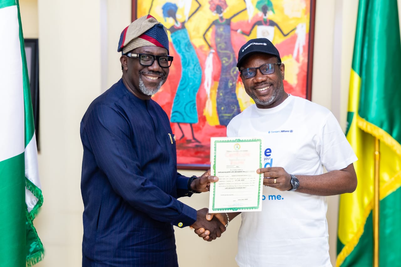 NAICOM Commissioner presents insurance licenses to SanlamAllianz officials during official ceremony in Abuja