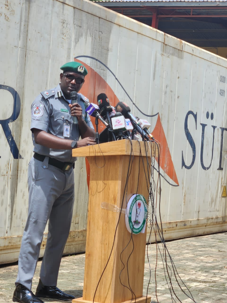 Nigerian Customs officers inspecting bags of seized donkey genitals at a warehouse after wildlife trafficking interception.