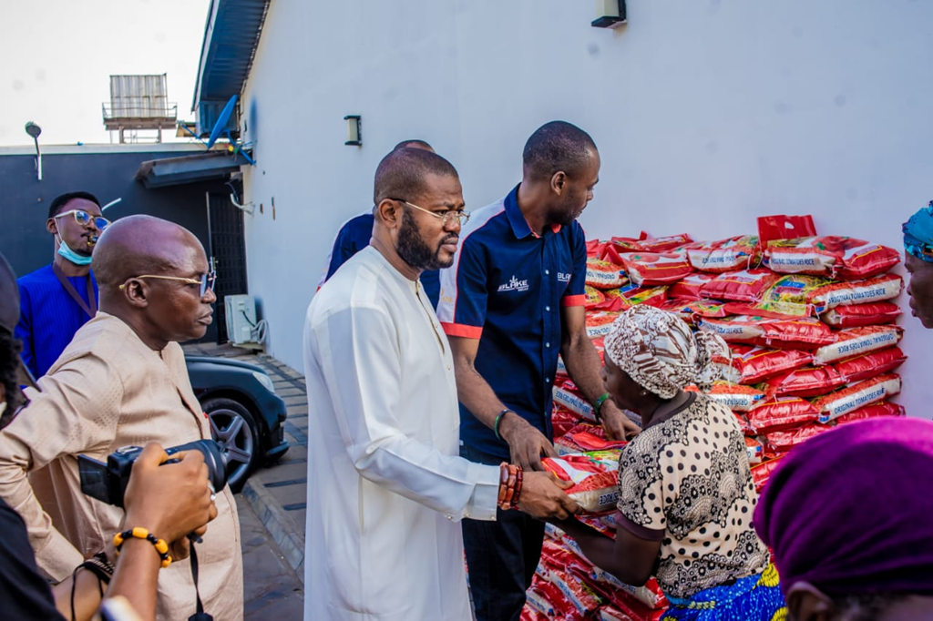 Widows queue to receive food items and cash support during an outreach programme in Abuja.