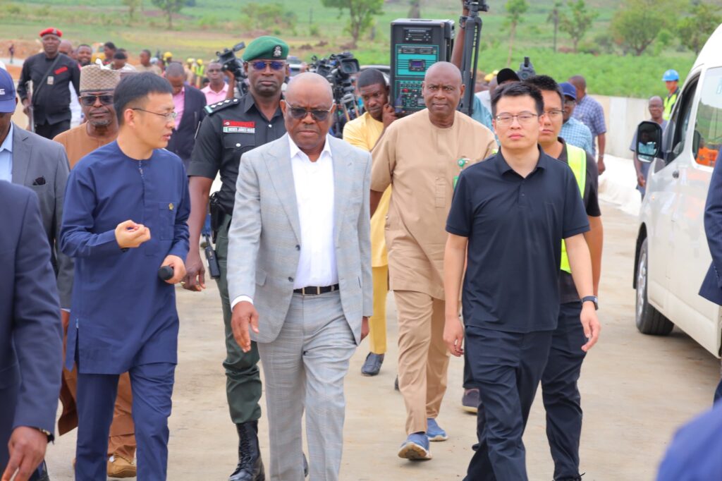 Nyesom Wike inspecting ongoing road construction and conference centre annex projects in Abuja, speaking with engineers and contractors on site.