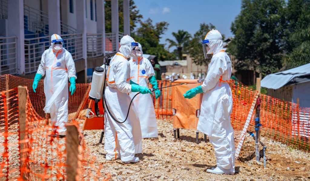 Health workers in protective gear respond to an Ebola outbreak as public gathering restrictions take effect in Kinshasa and other DR Congo provinces.