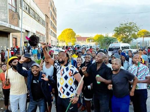 South African police officers patrol a city street as authorities prepare for planned anti-immigration protests.