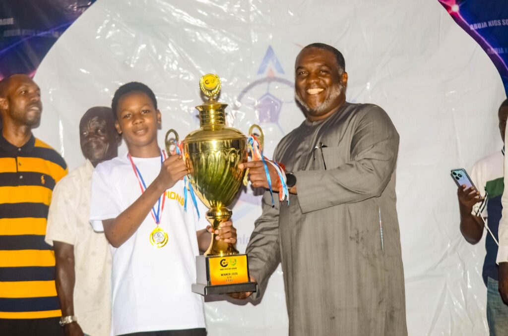 Young footballers celebrate with trophies during the 2026 Kids Soccer League grand finale in Abuja after Refined Nuggets FC and FAFC won their respective age-group titles